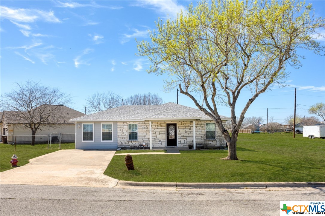 a front view of house with yard and green space