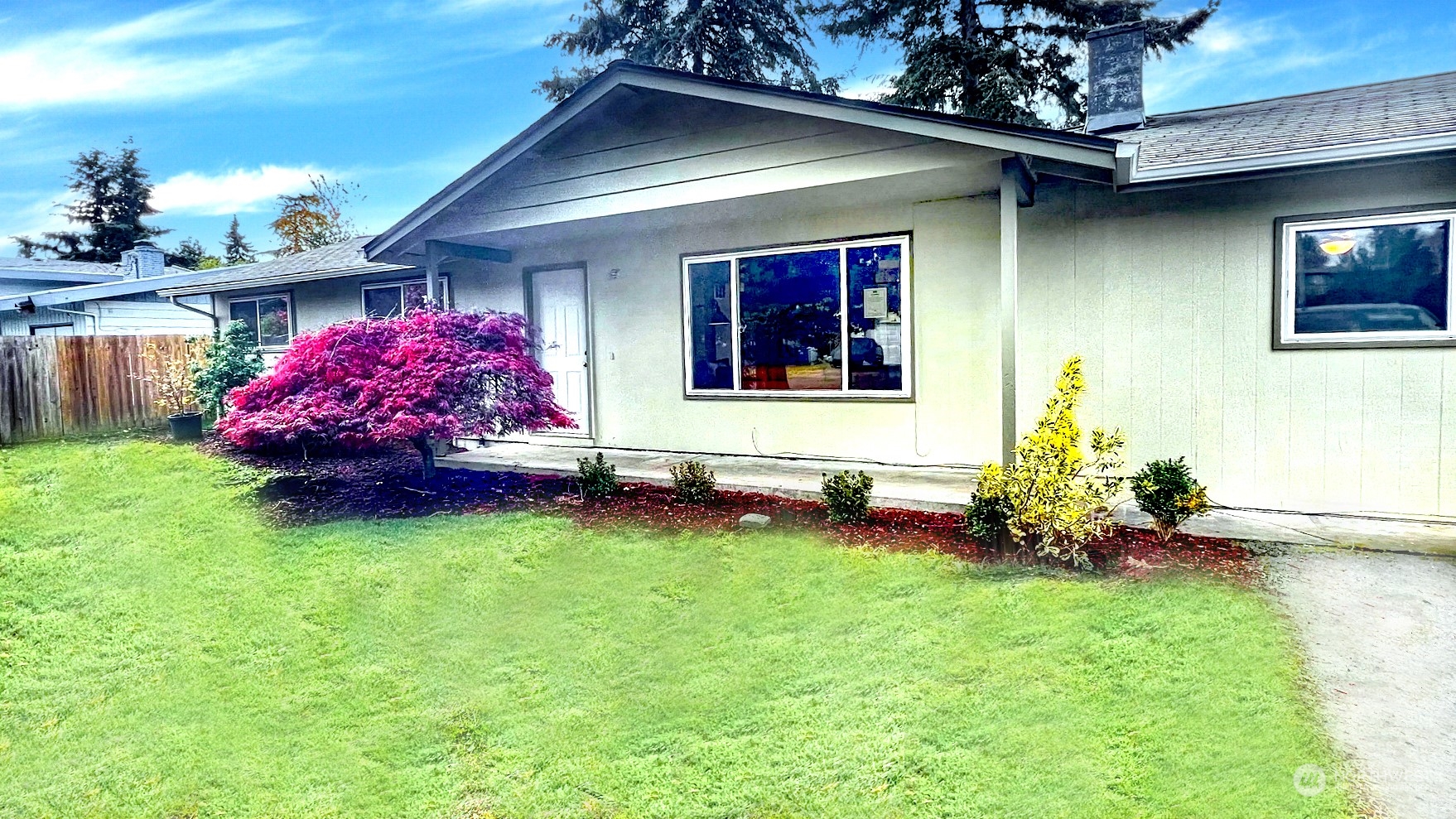 a front view of a house with garden