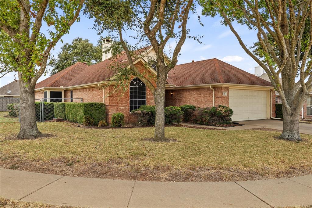 a house that has a tree in front of it