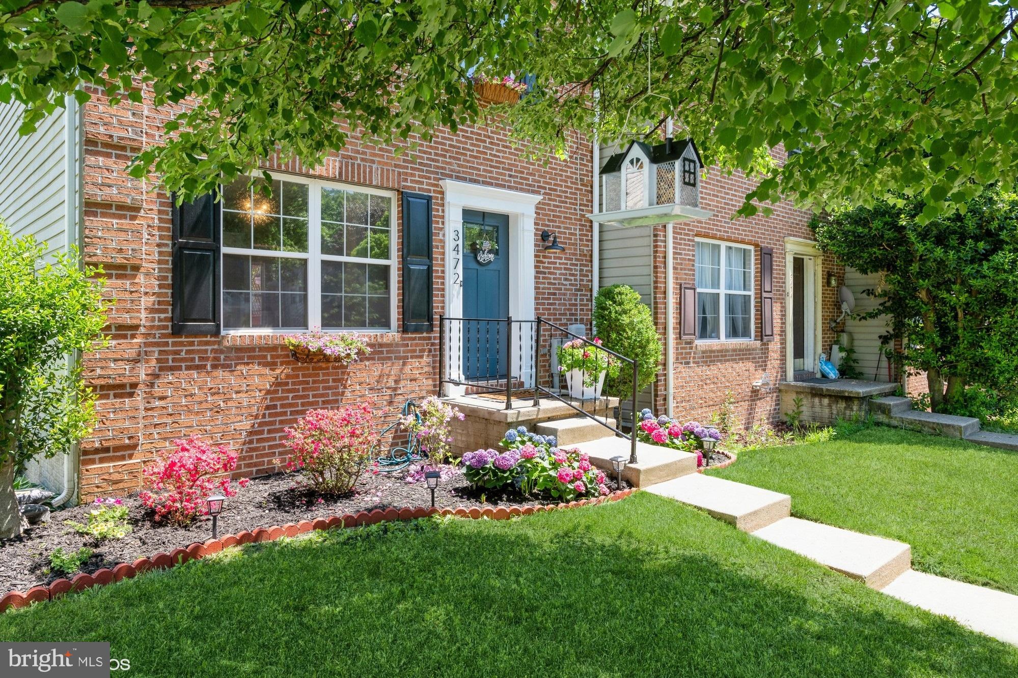 a front view of a house with garden