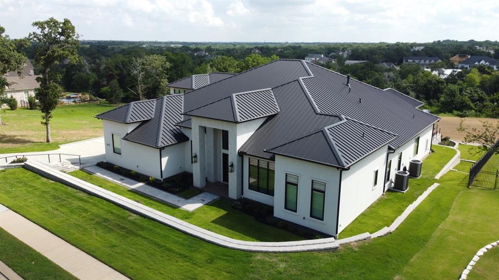 an aerial view of a house with swimming pool