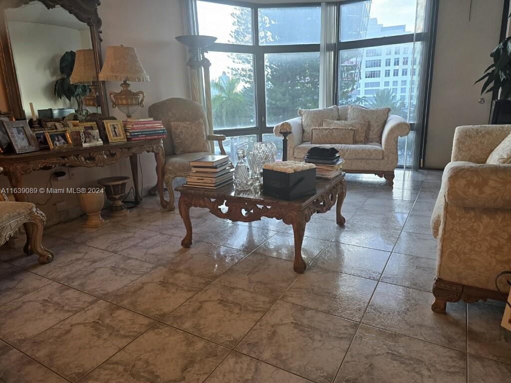 a living room with furniture and a floor to ceiling window