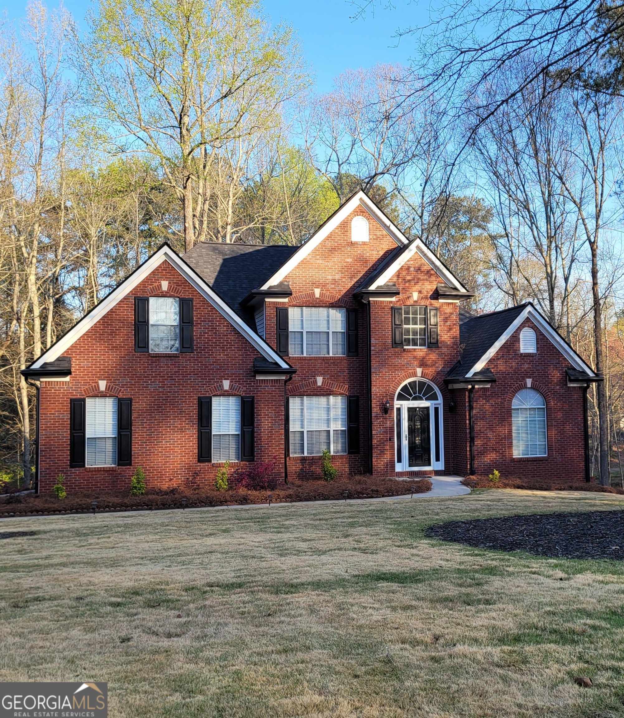 a front view of a house with a yard