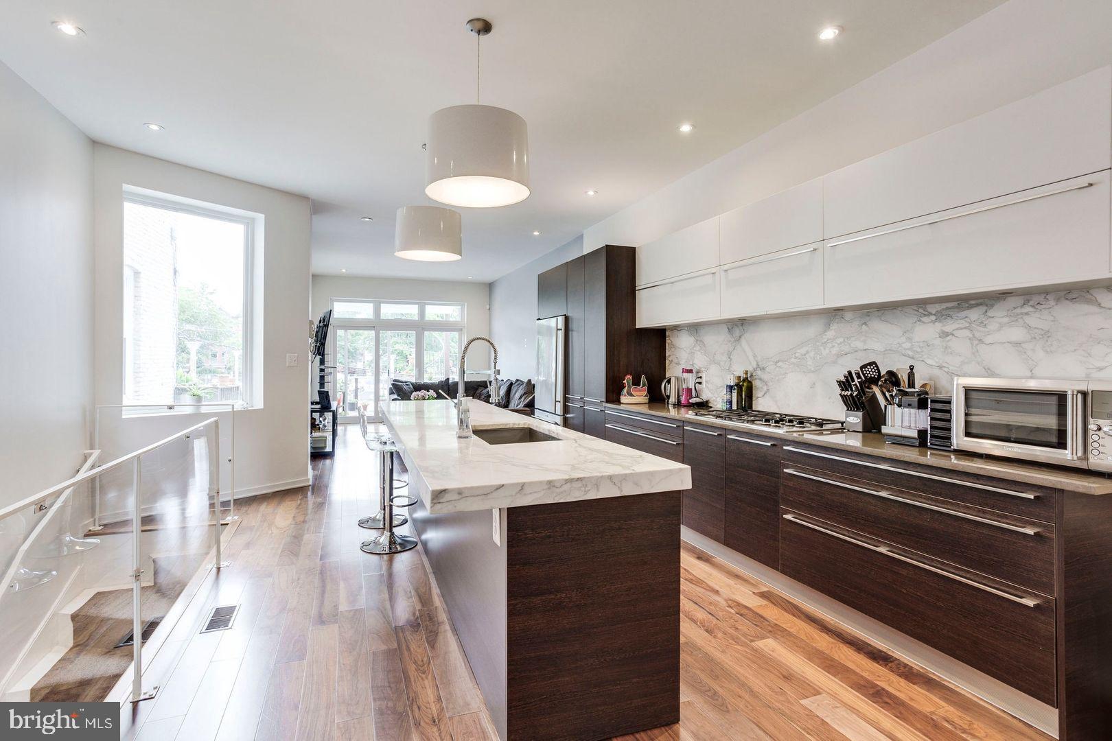 a open kitchen with sink and cabinets