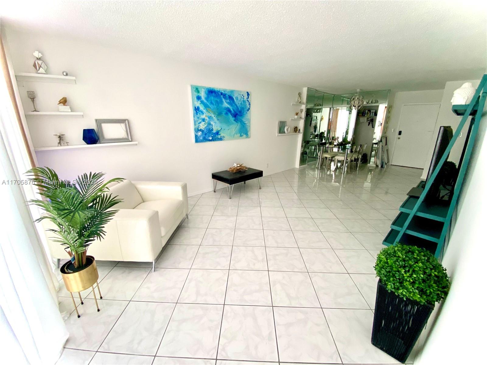 a view of living room with furniture and wooden floor