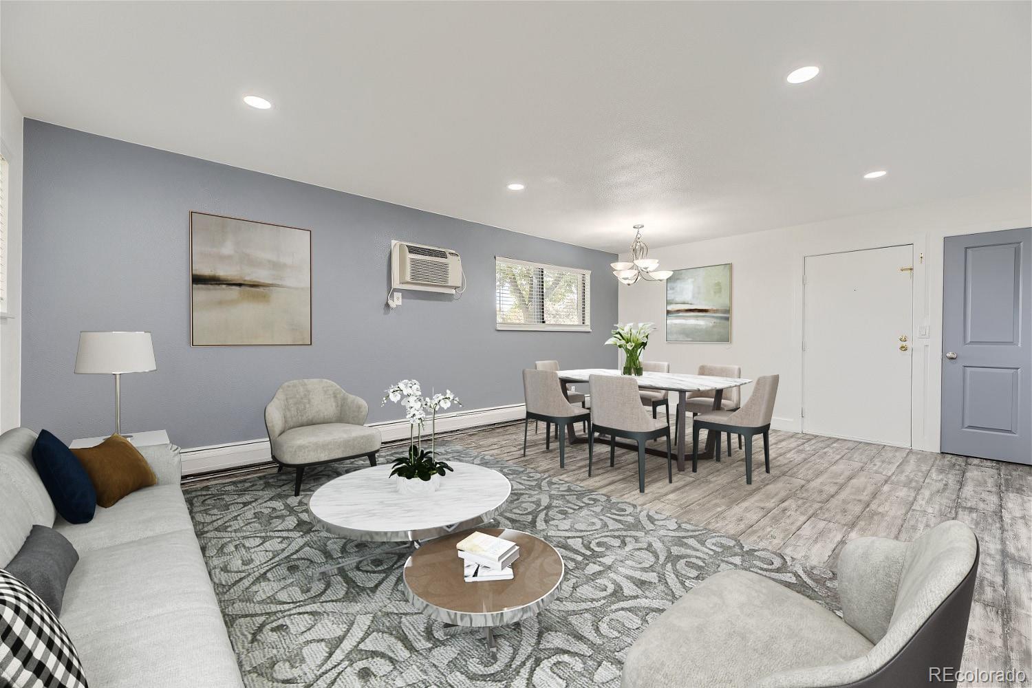 a living room with furniture and view of kitchen