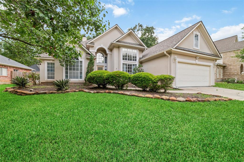 a front view of a house with a yard and outdoor seating