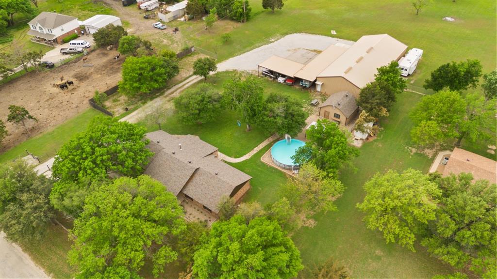 an aerial view of a house with yard swimming pool and outdoor seating