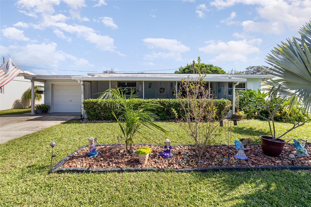 a front view of house with yard and outdoor seating