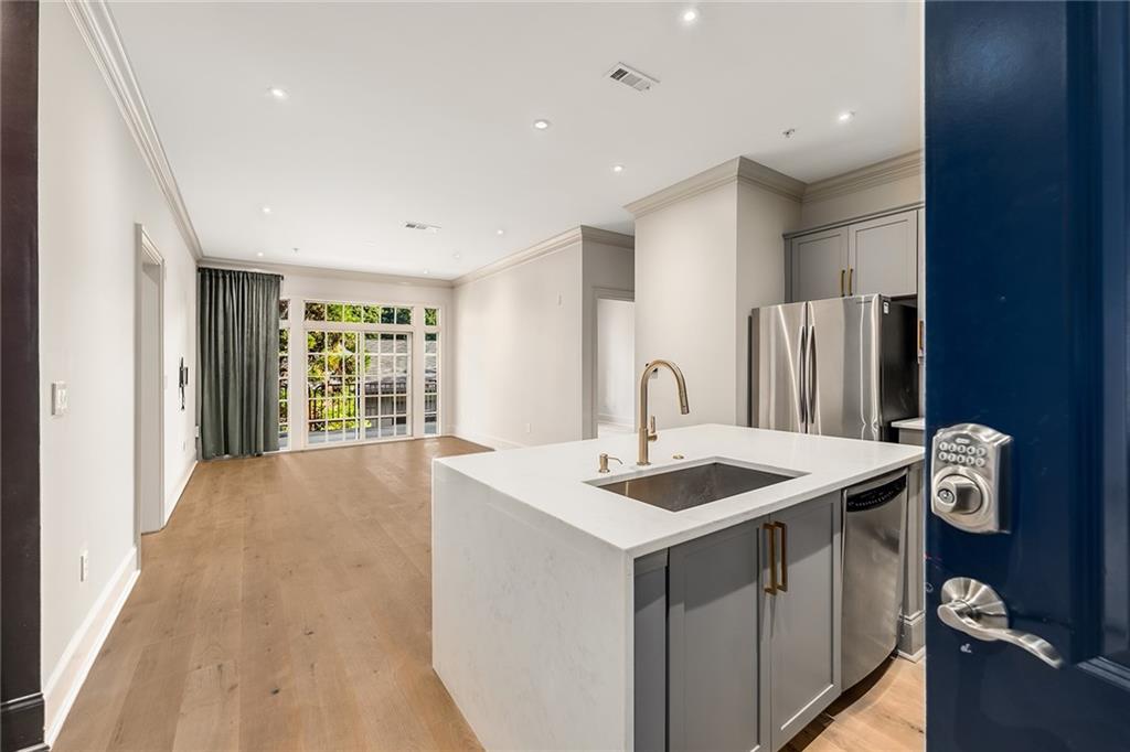 a kitchen that has a sink a stove and a refrigerator