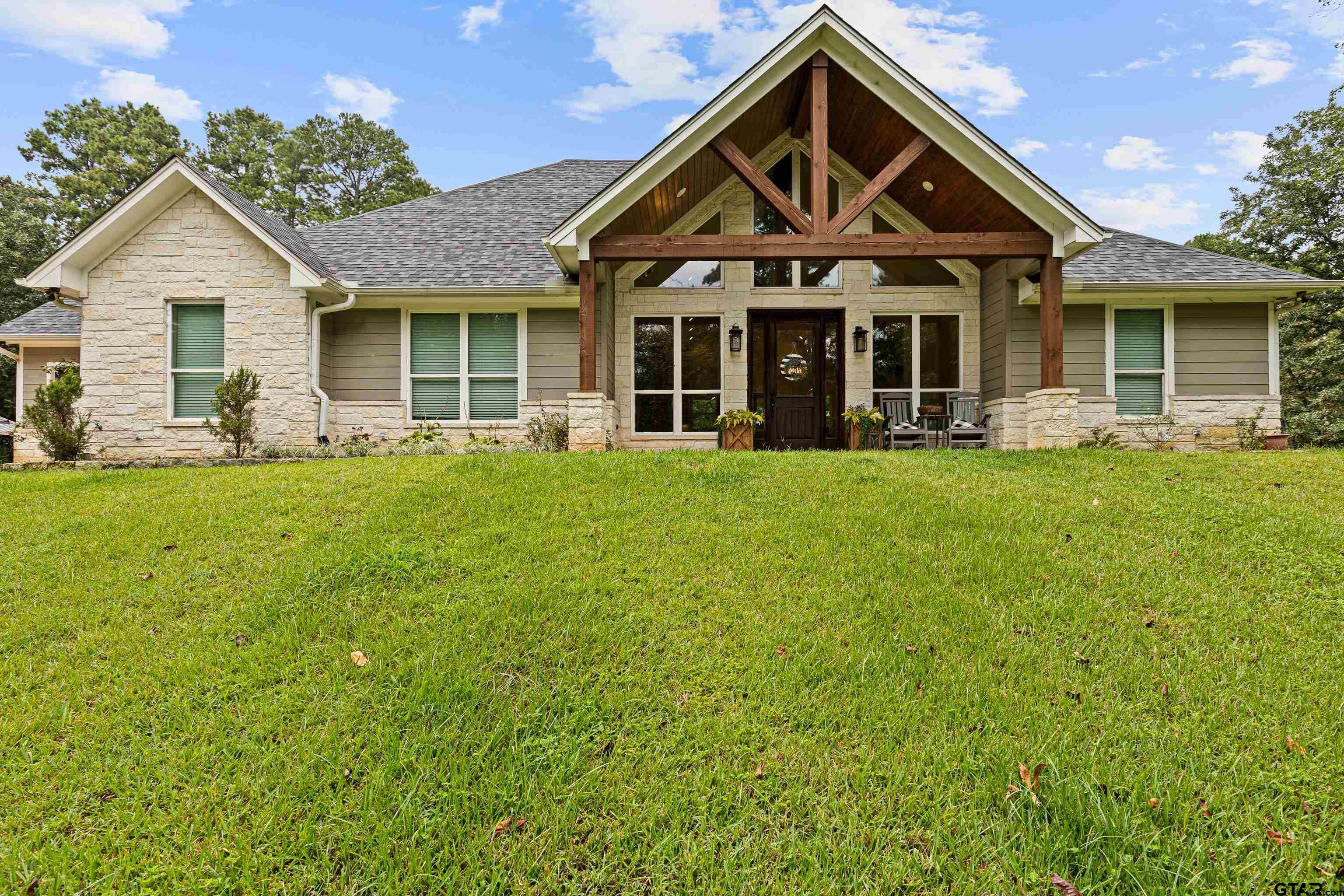 a front view of a house with a yard and porch