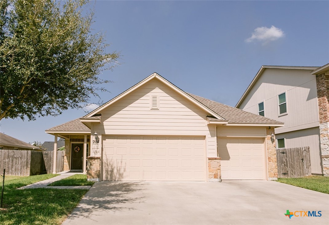 a view of a house with a yard and garage