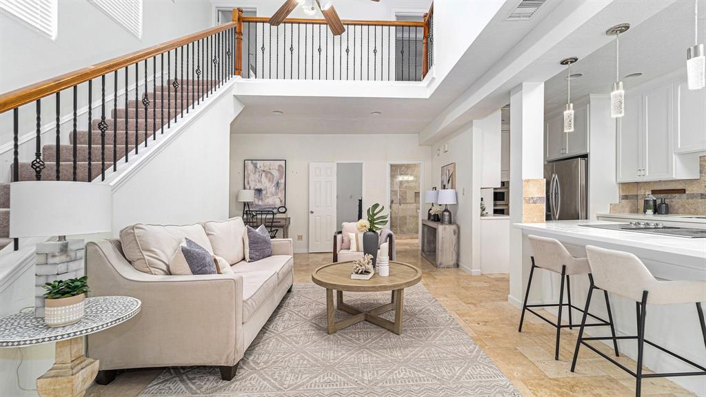 a living room with furniture and a dining table