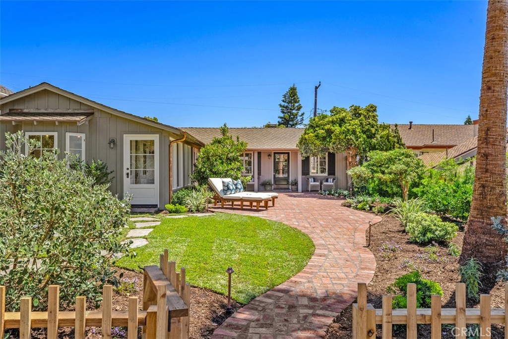 a view of a house with backyard and sitting area