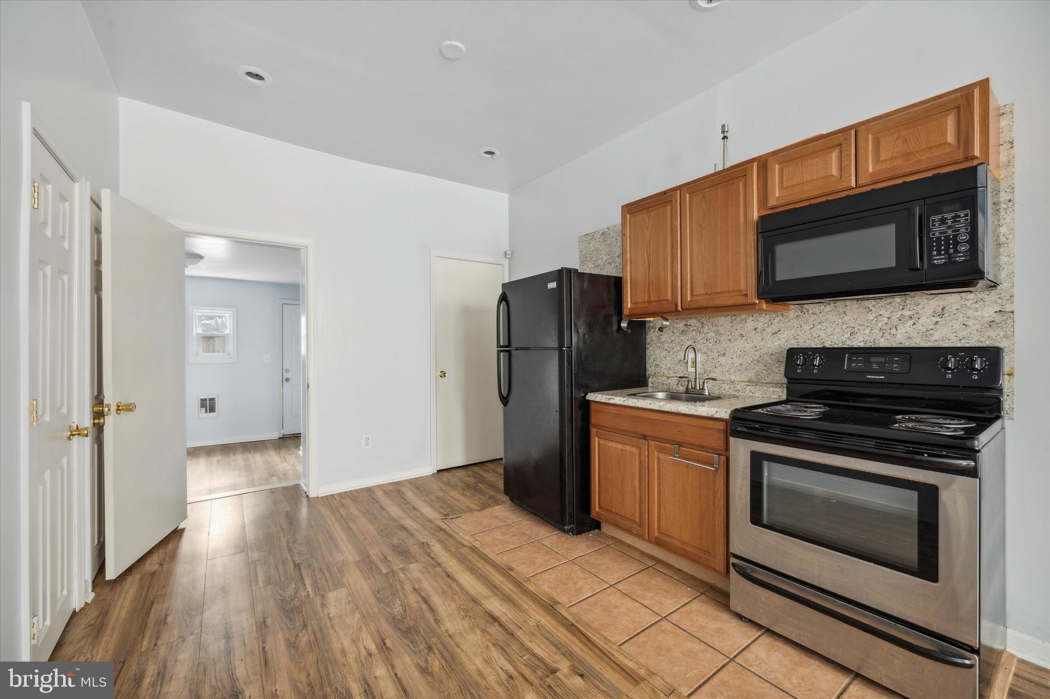 a kitchen with a stove microwave and refrigerator