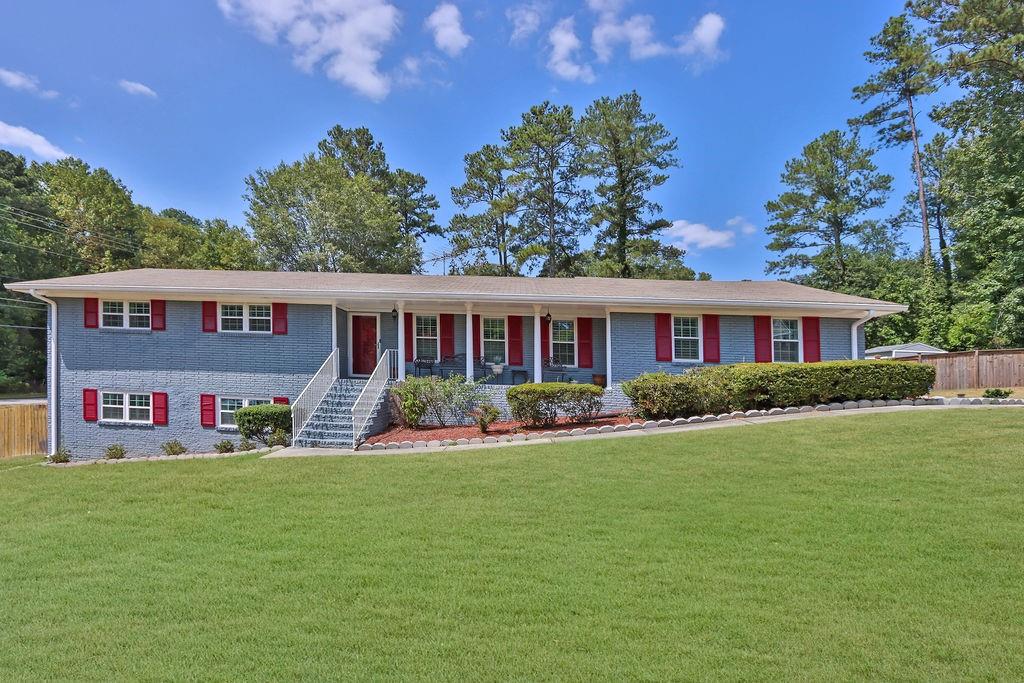 a front view of a house with a garden