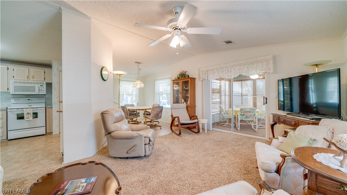 a living room with furniture and large windows