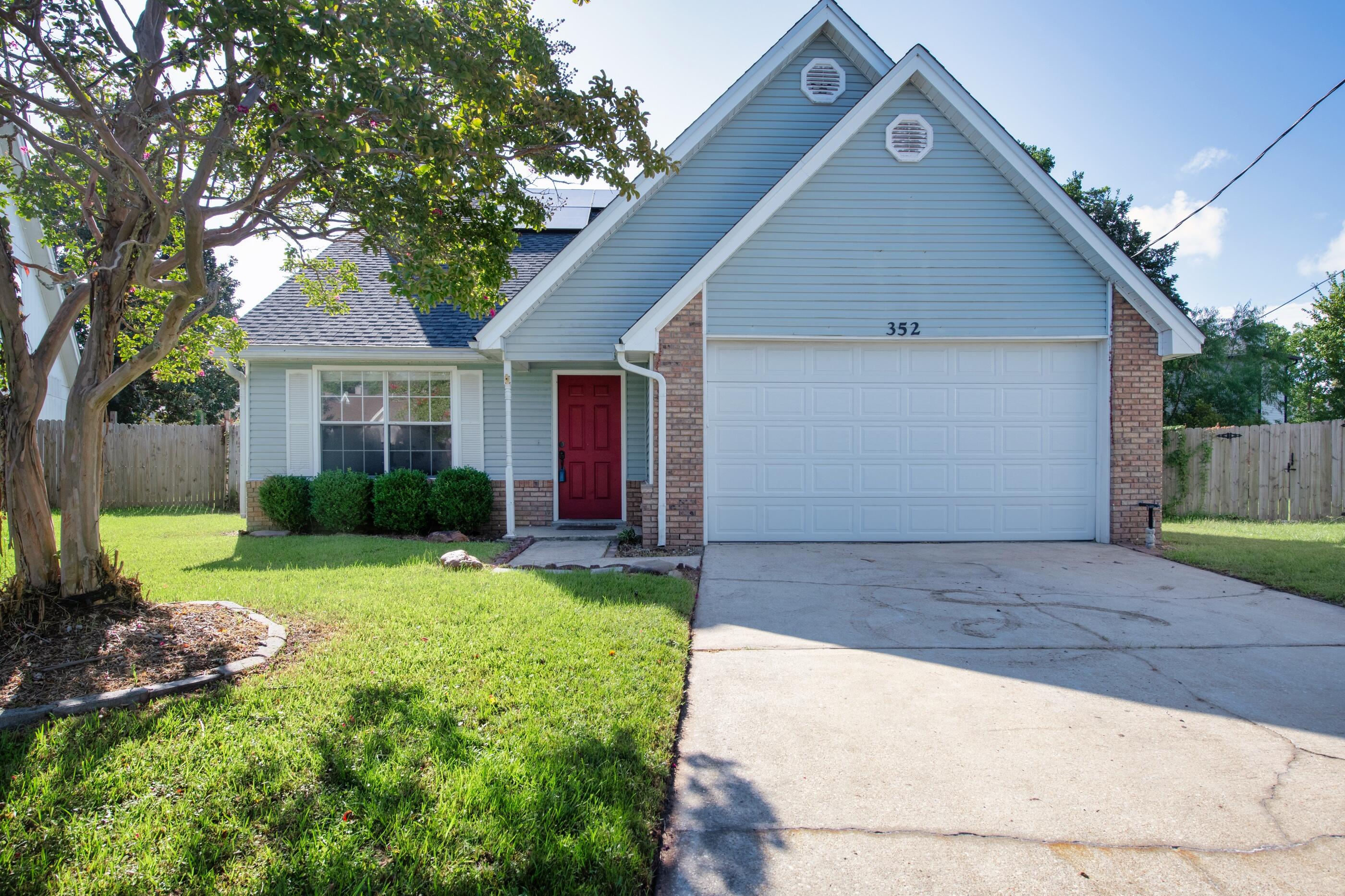 a front view of house with yard and green space