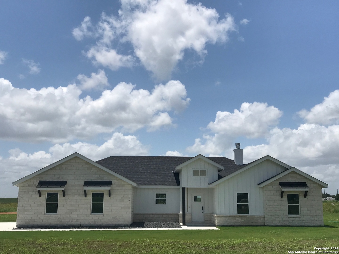 a front view of house with yard and green space