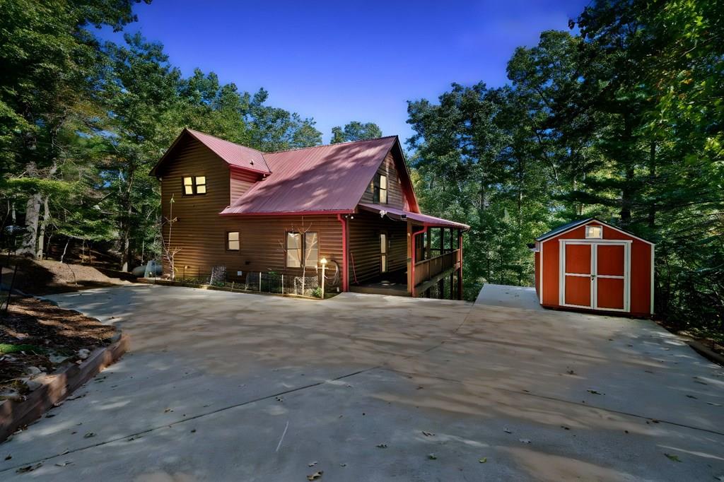 a front view of a house with trees and plants