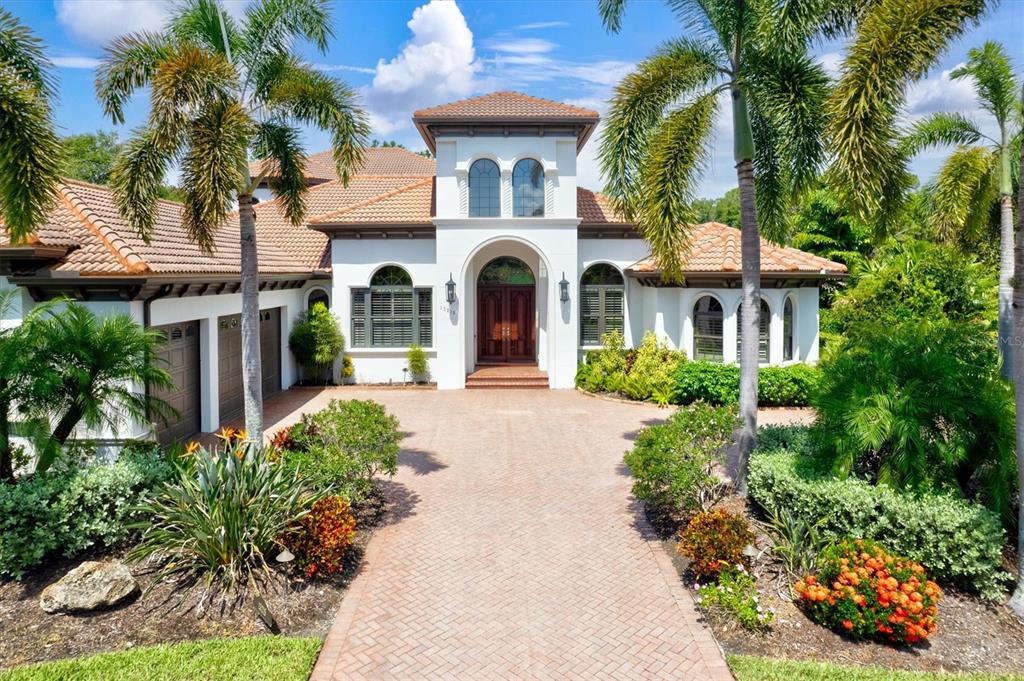 a front view of a house with a garden