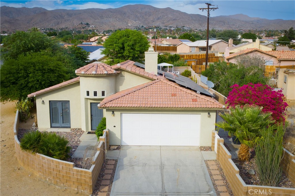 a aerial view of a house next to a yard