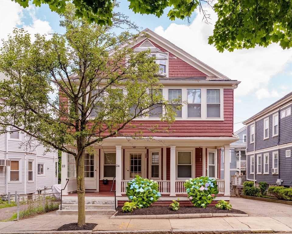 a front view of a residential houses with yard