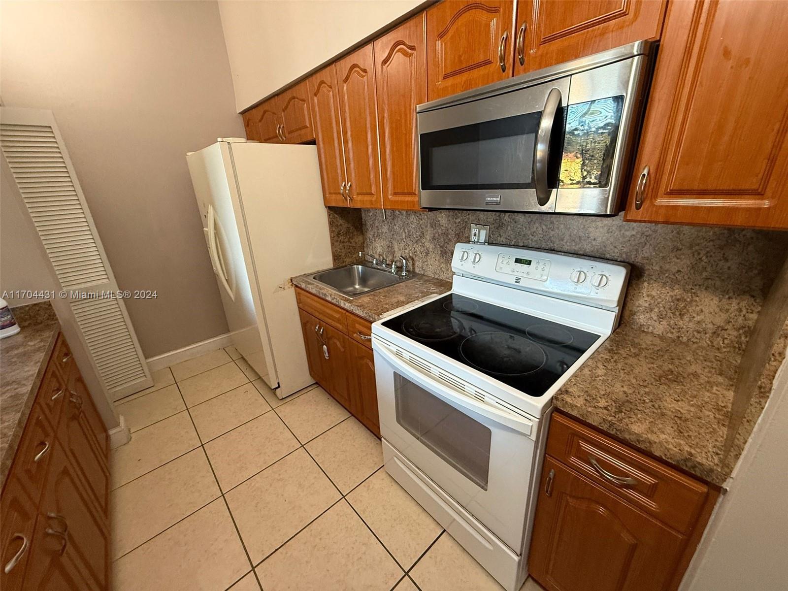 a kitchen with a stove microwave and sink