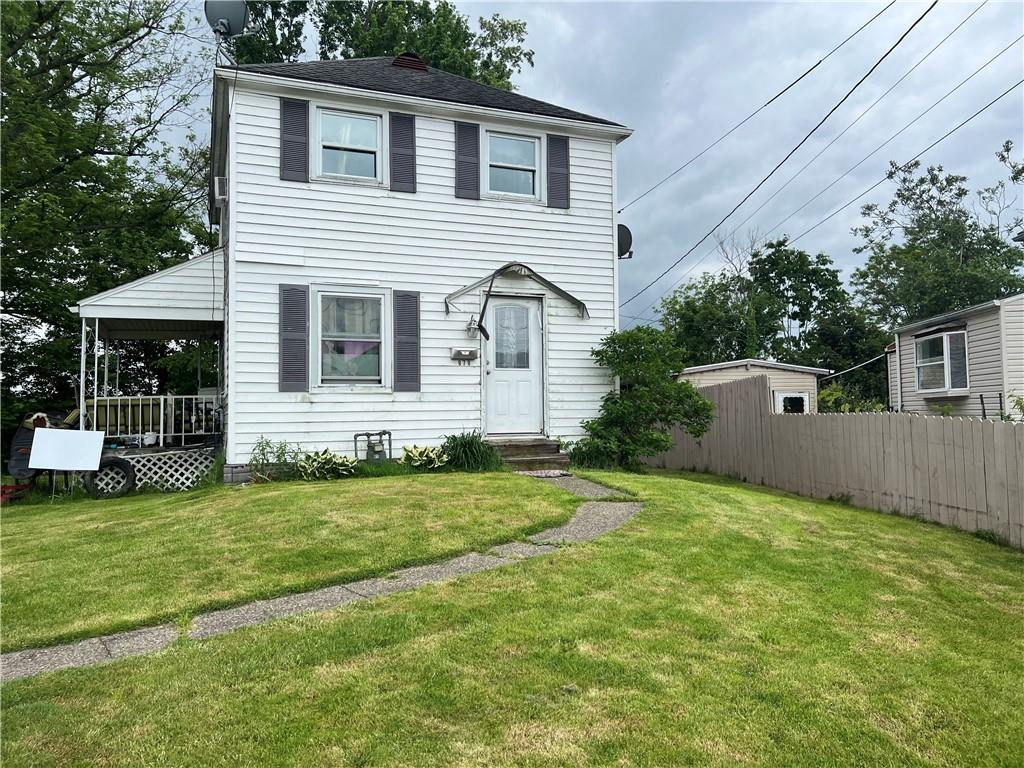 a front view of a house with a garden and yard