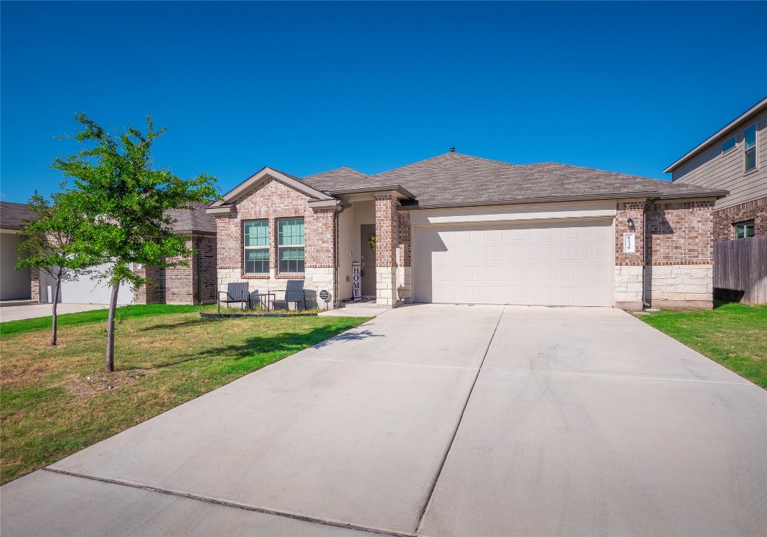 a front view of a house with a yard and garage