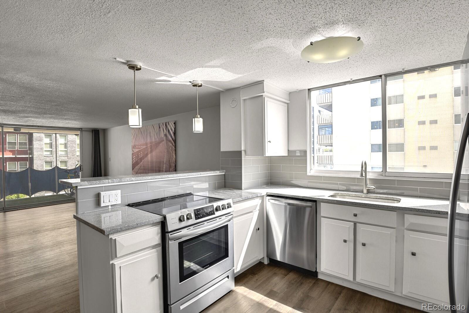 a kitchen with a stove sink and window