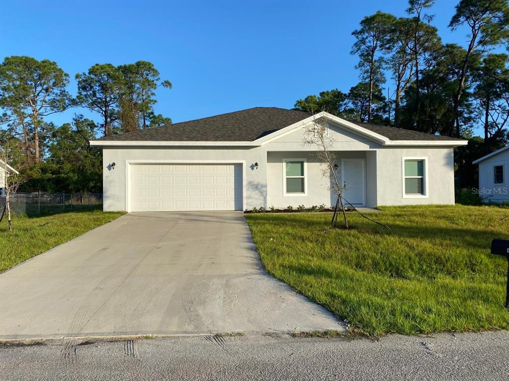 a front view of a house with a yard and garage