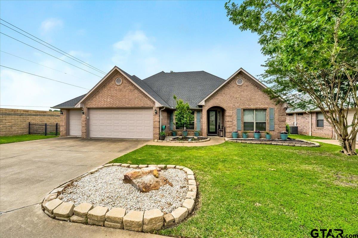 a view of a house with a yard patio and fire pit