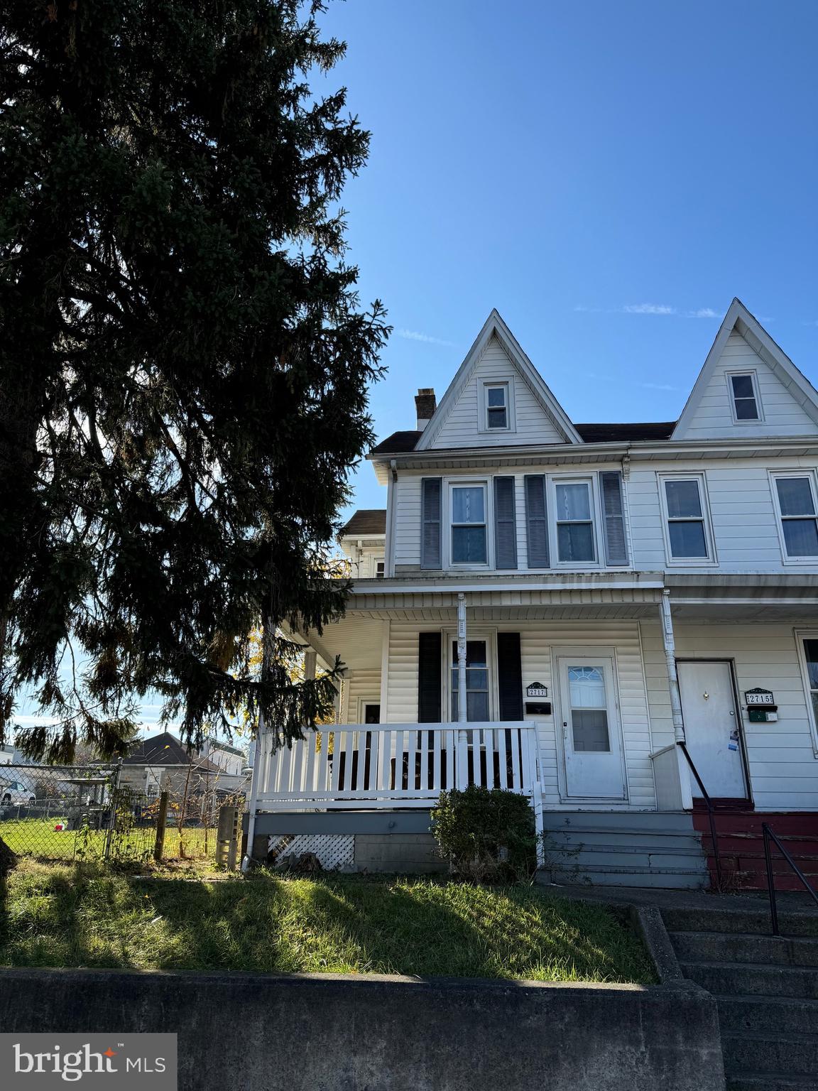 a front view of a house with a garden and yard