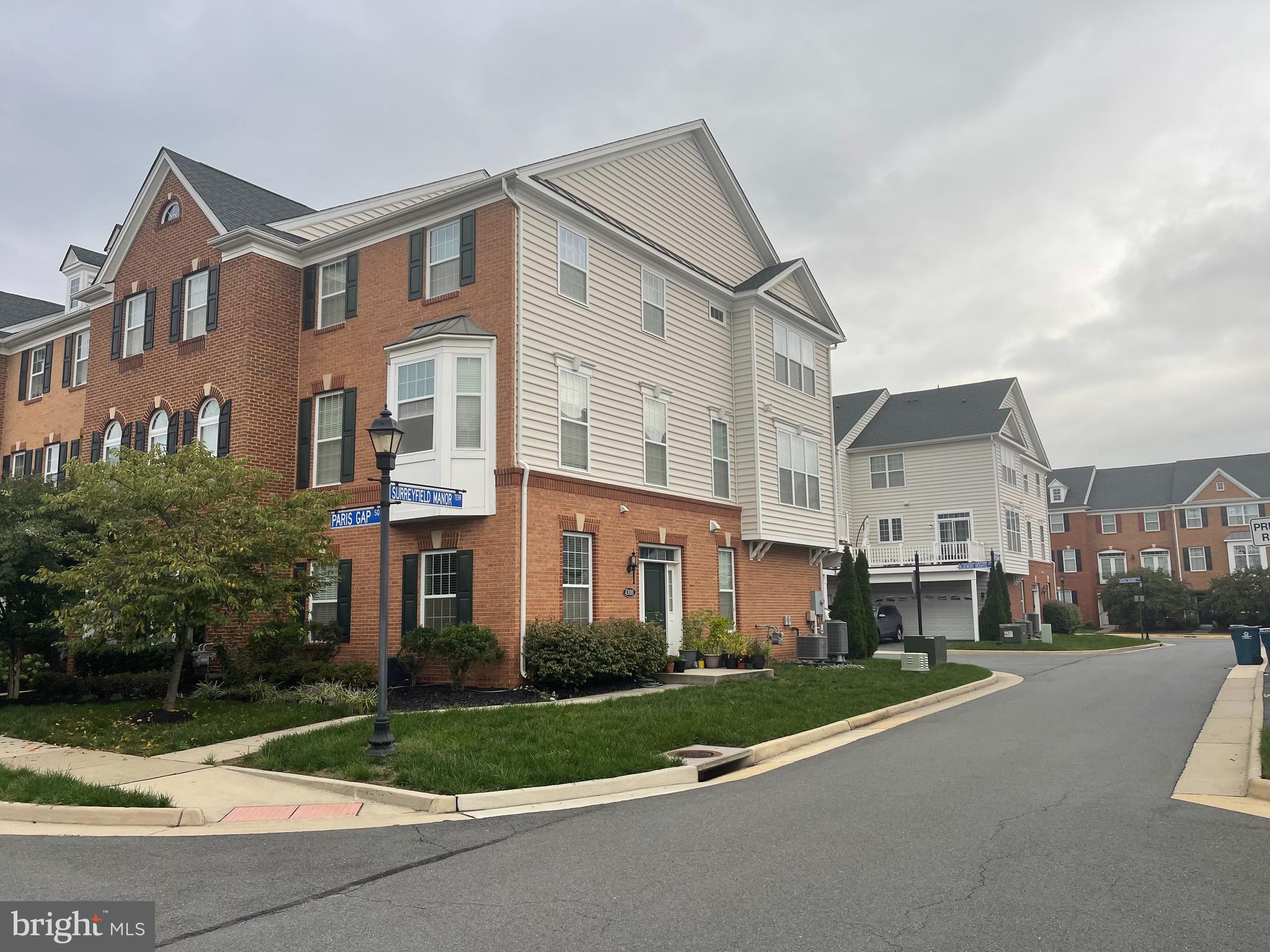 a front view of a residential apartment building with a yard