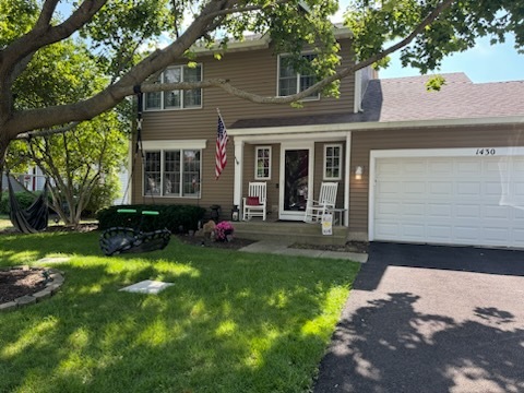 a front view of a house with a yard and porch