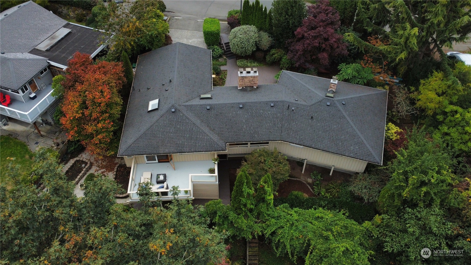 an aerial view of a house with a yard and trees