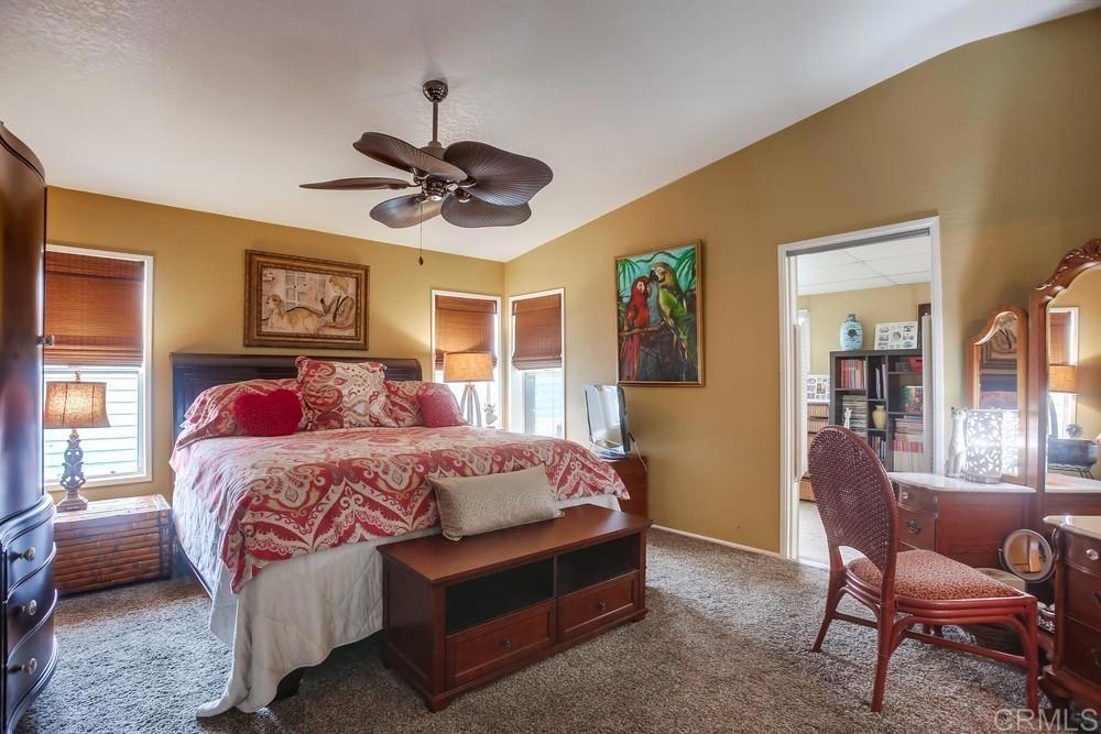 a bedroom with a bed a chandelier and a window