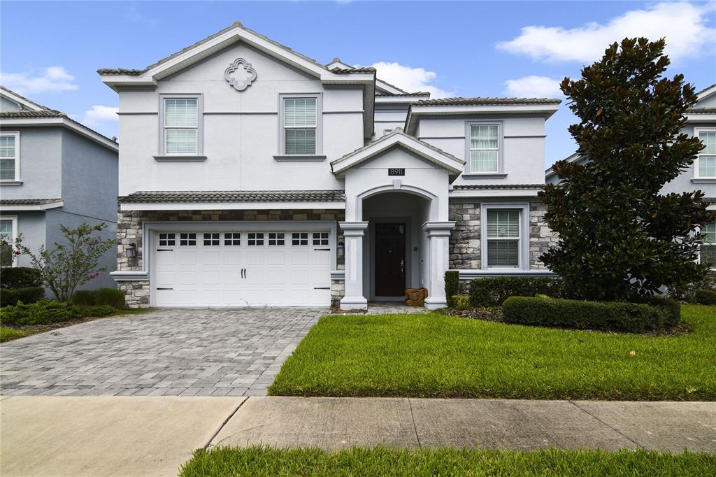 a front view of a house with a yard and garage