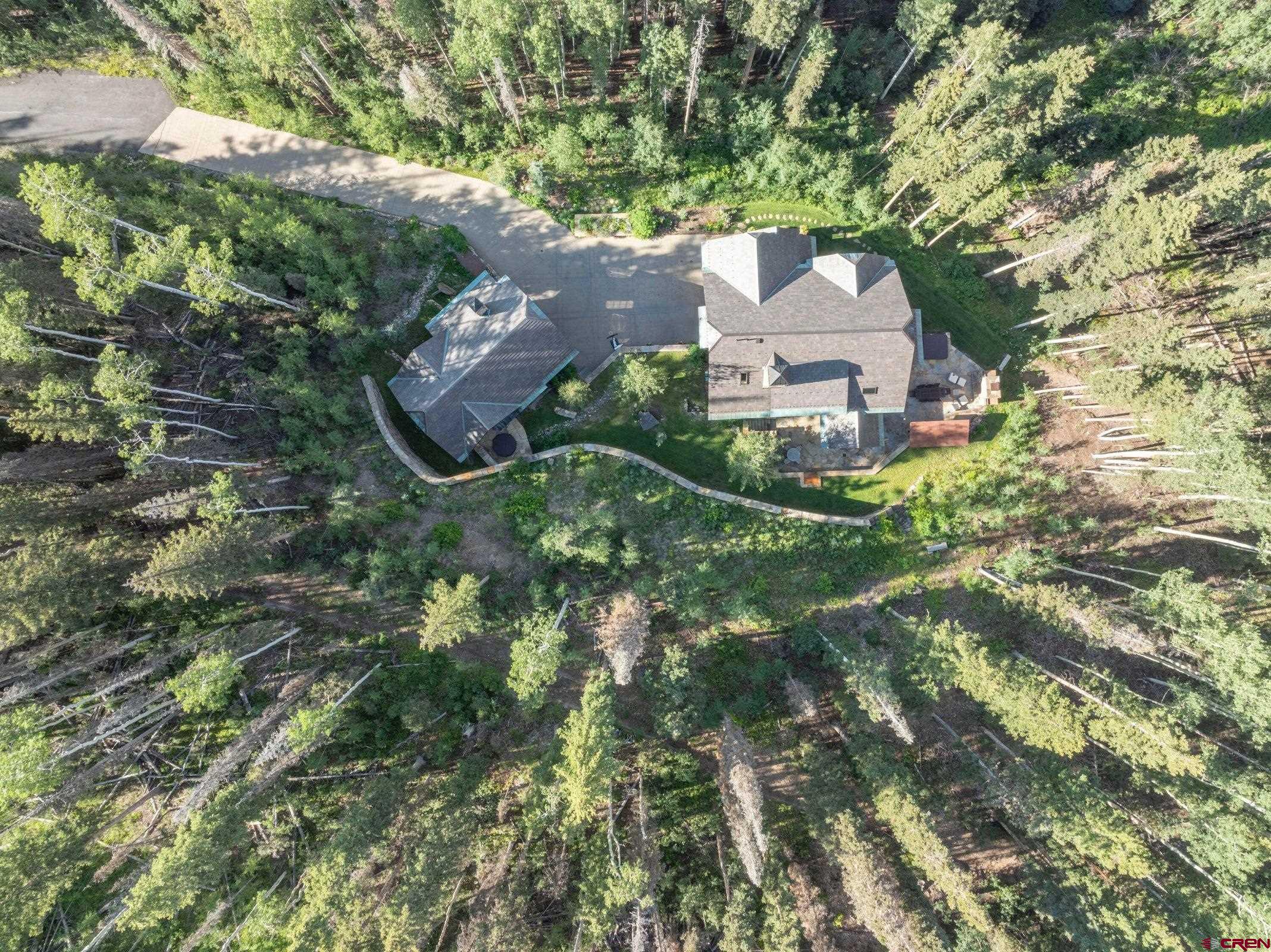 an aerial view of a house with yard