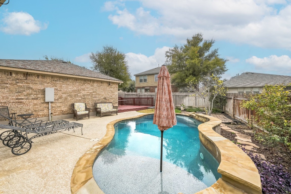 a view of a patio with swimming pool