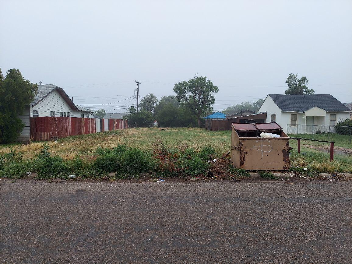 a front view of a house with a garden and yard