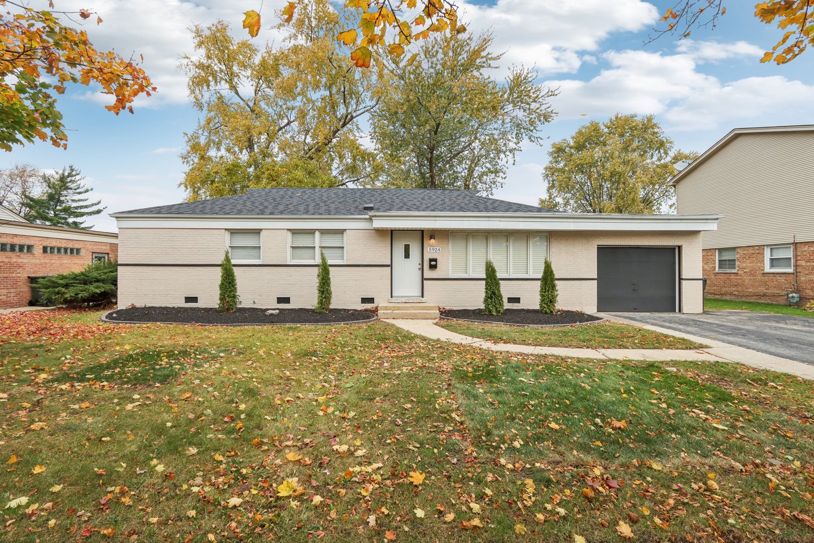 a view of a house with a yard and garage