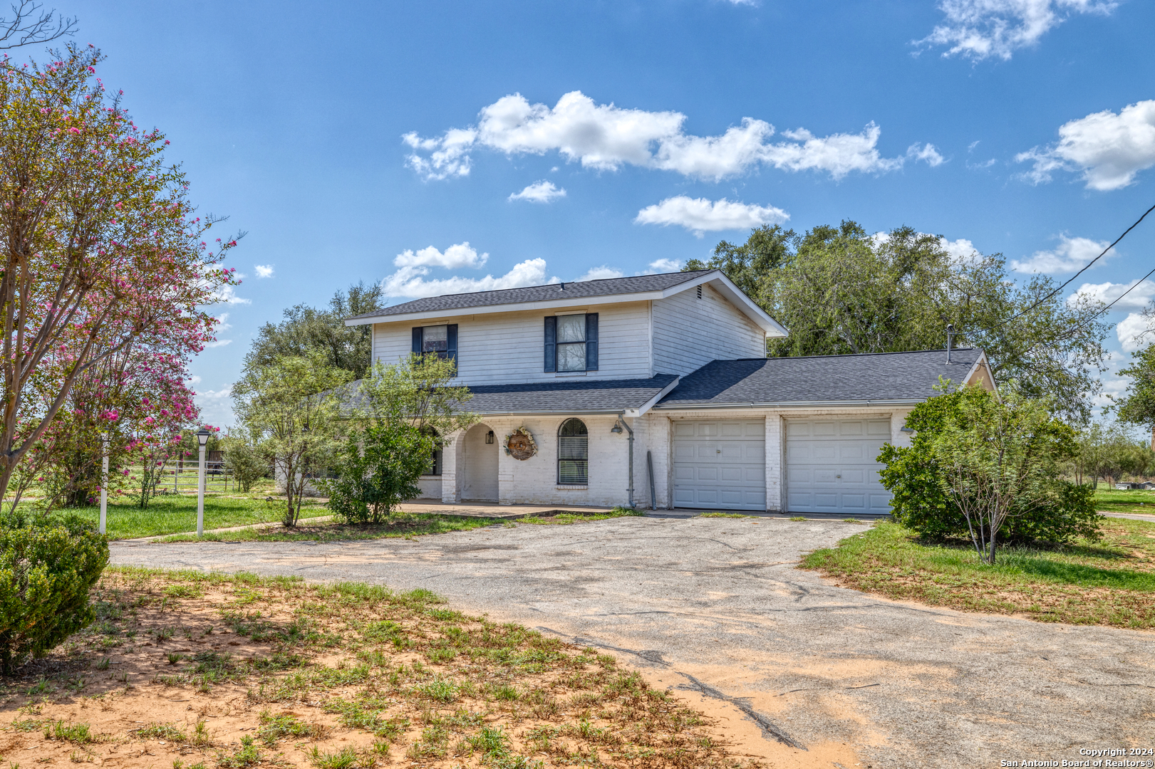 a front view of a house with a yard and a garage