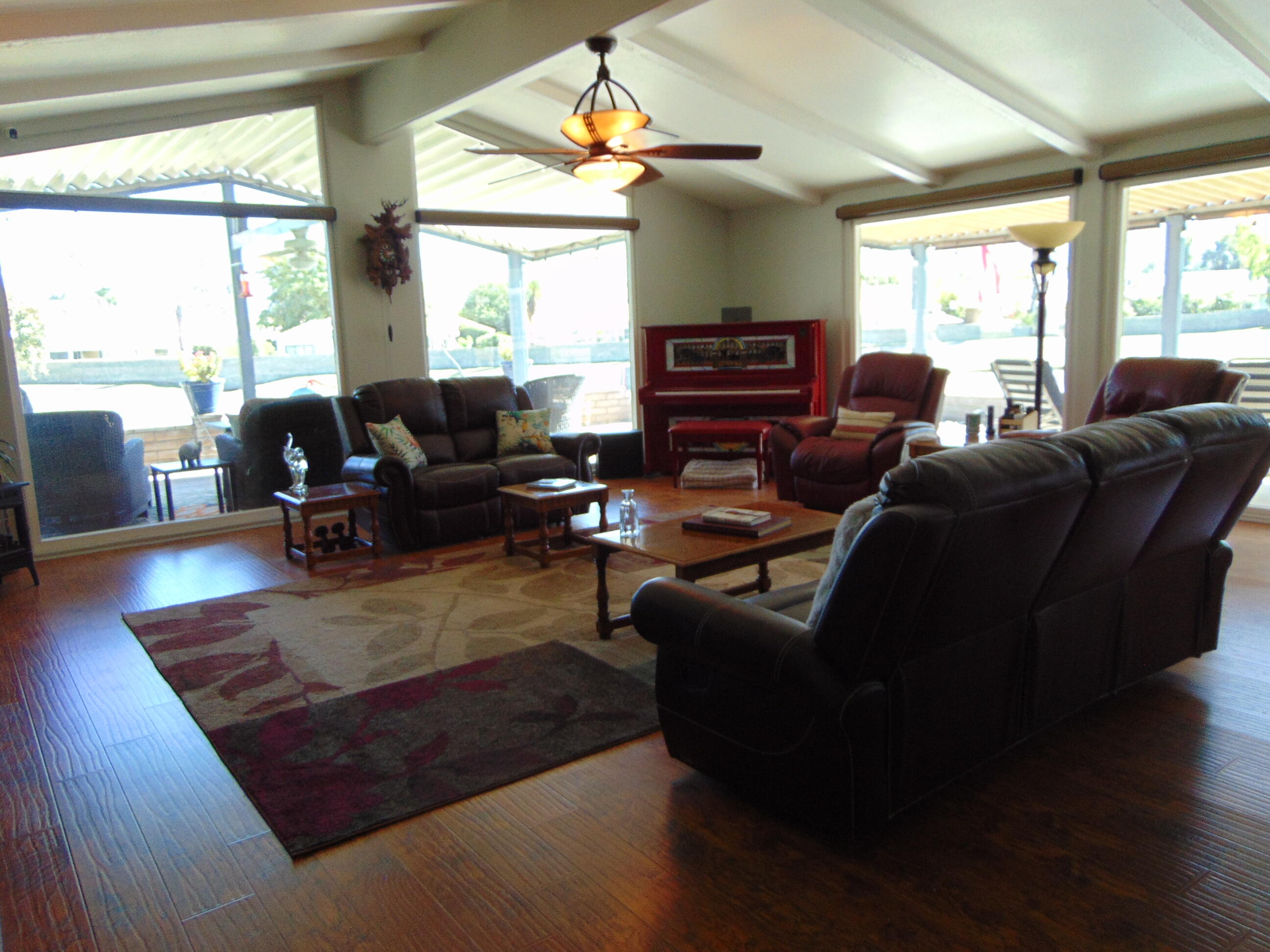 a living room with furniture fireplace and a large window