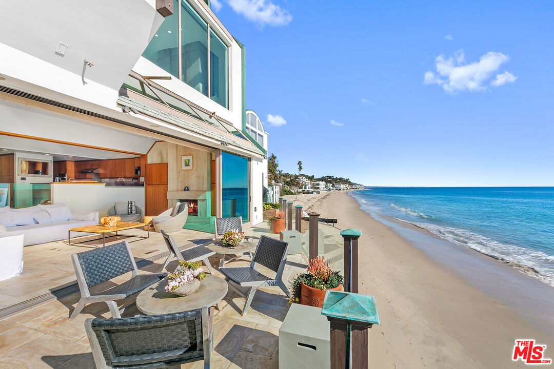 a view of a patio with dining table and chairs with wooden floor