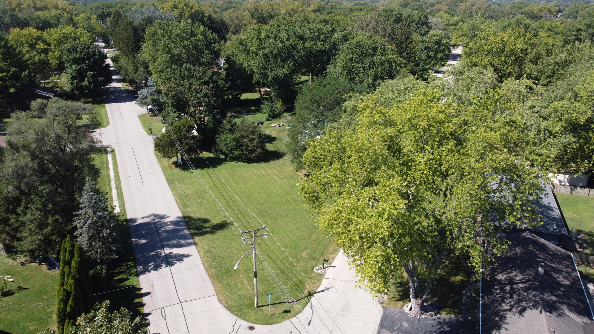 an aerial view of a house with swimming pool and trees