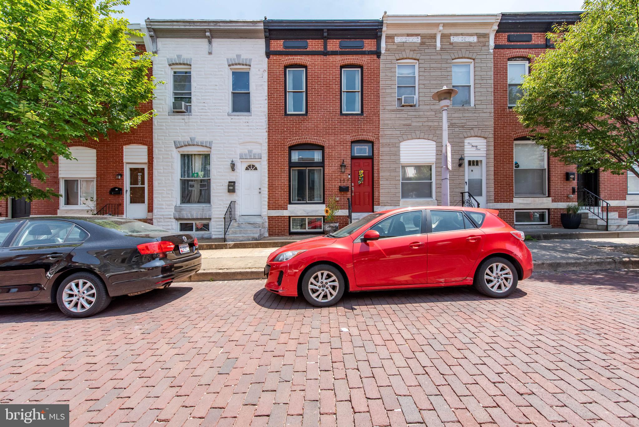 a cars parked in front of a brick building