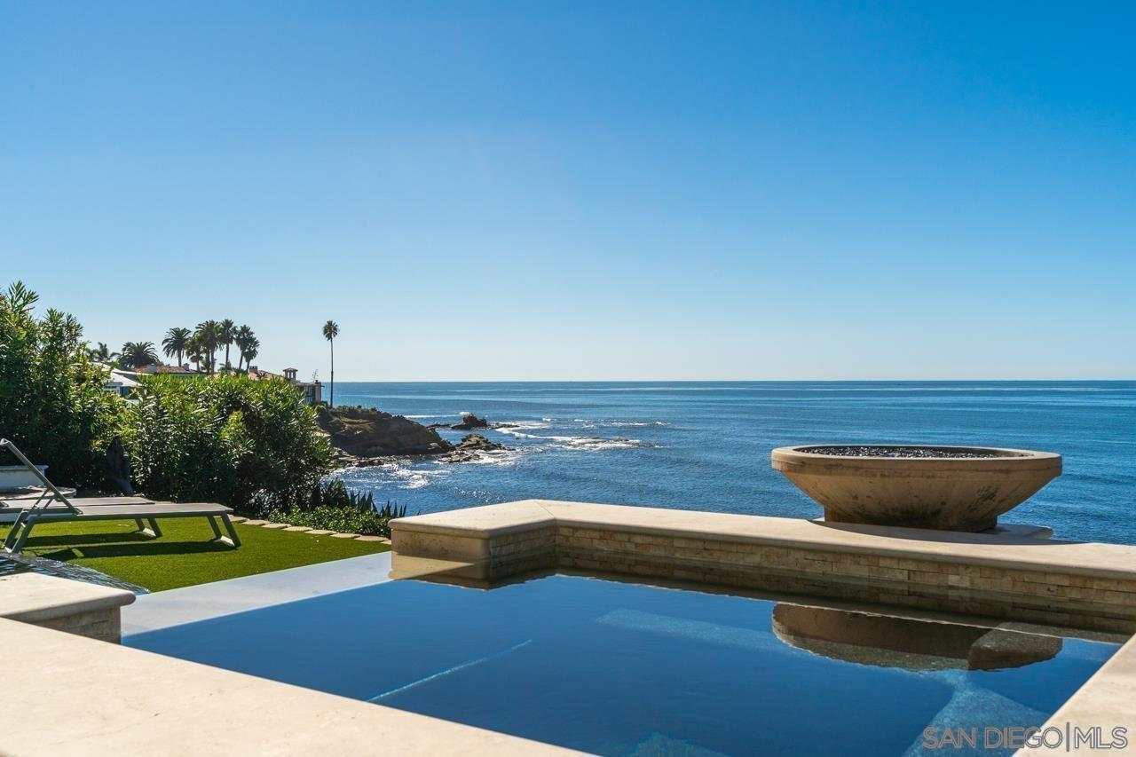 a view of a swimming pool with an outdoor space and seating area