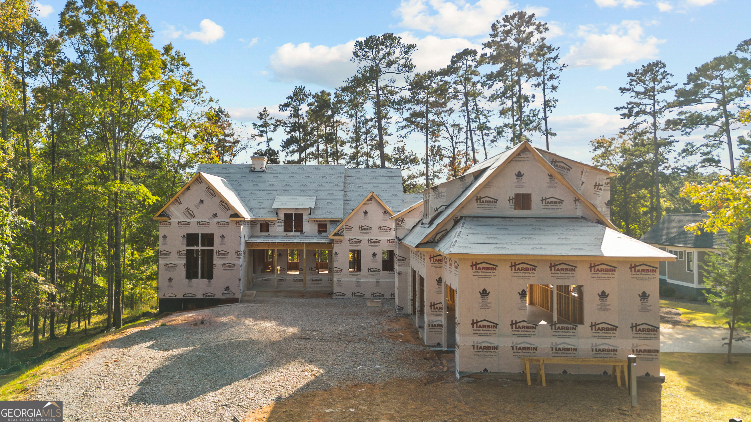 a view of a house with wooden fence